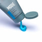 Johnny B. Mode styling gel in a gray tube with a blue gel pouring out for hair styling