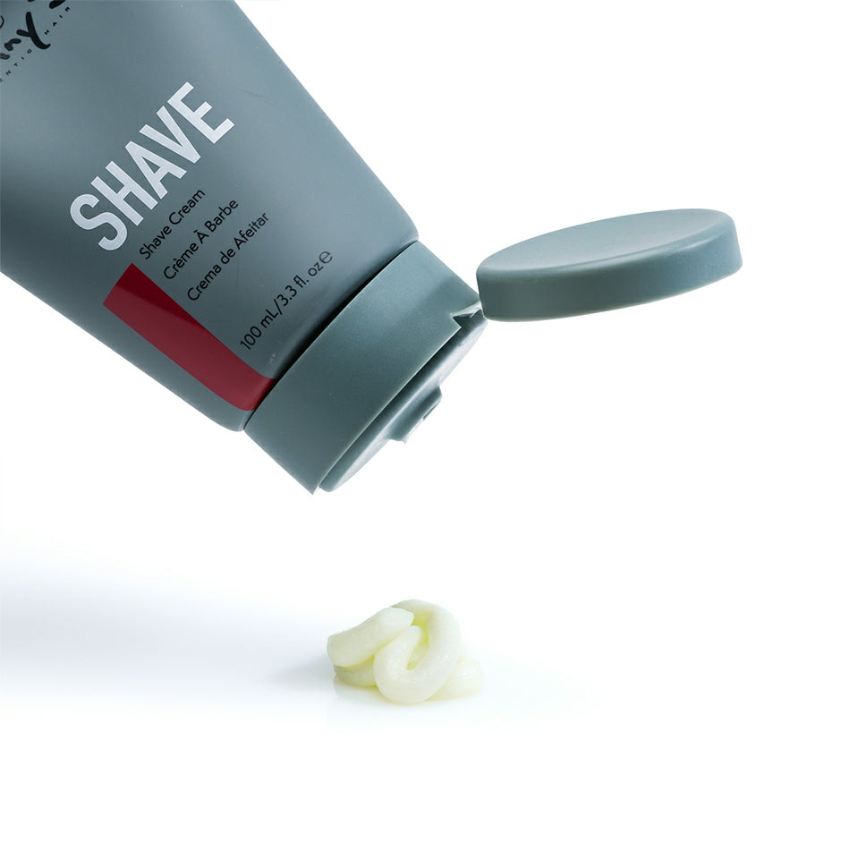 Johnny B shave cream in a gray tube with a flip-top lid and a small amount squeezed out