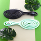 Knot Genie Detangling Brushes in Black and Mint with Spiral Design for Effortless Hair Care