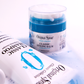 Original Sprout Classic Styling Balm in a clear jar with a blue lid, surrounded by shampoo bottles